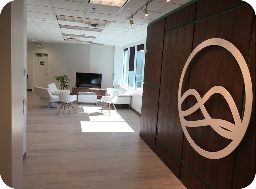 Grow office lobby with the wood-paneled logo wall