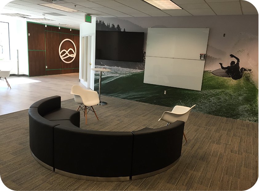 Grow office lounge with curved seating and the surf mural