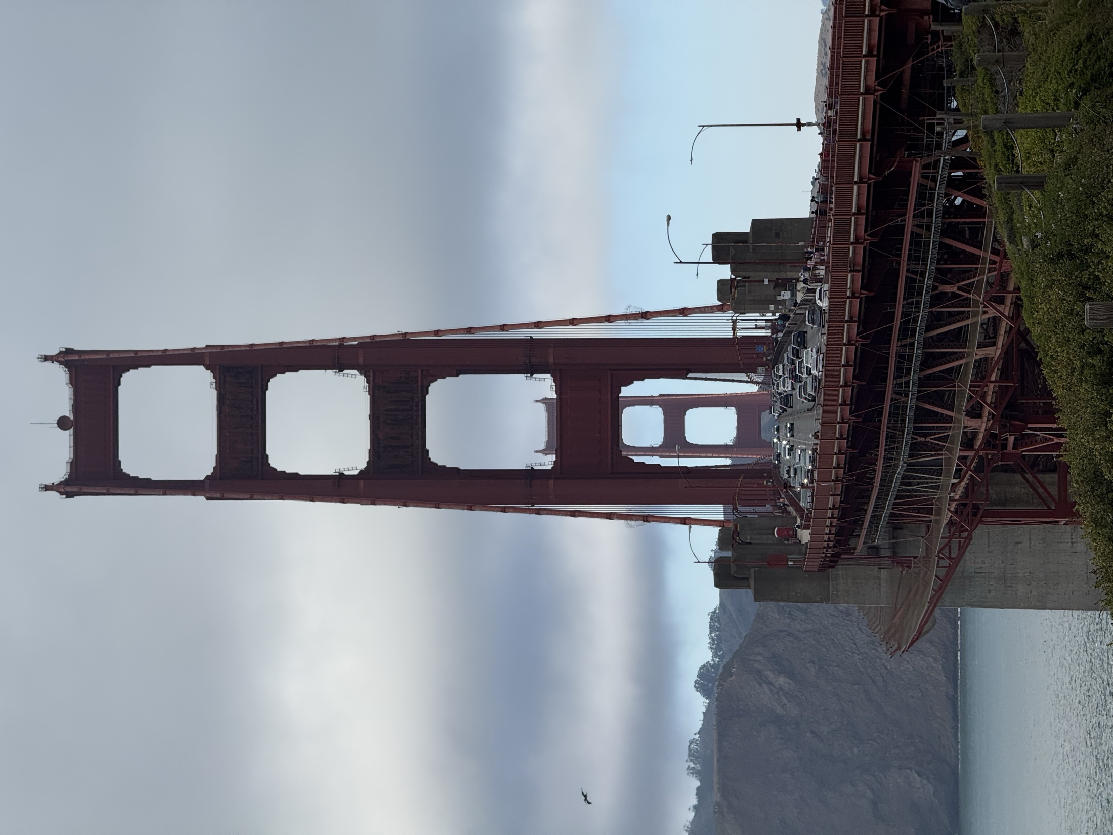 The Golden Gate Bridge at dusk, long exposure over the surf