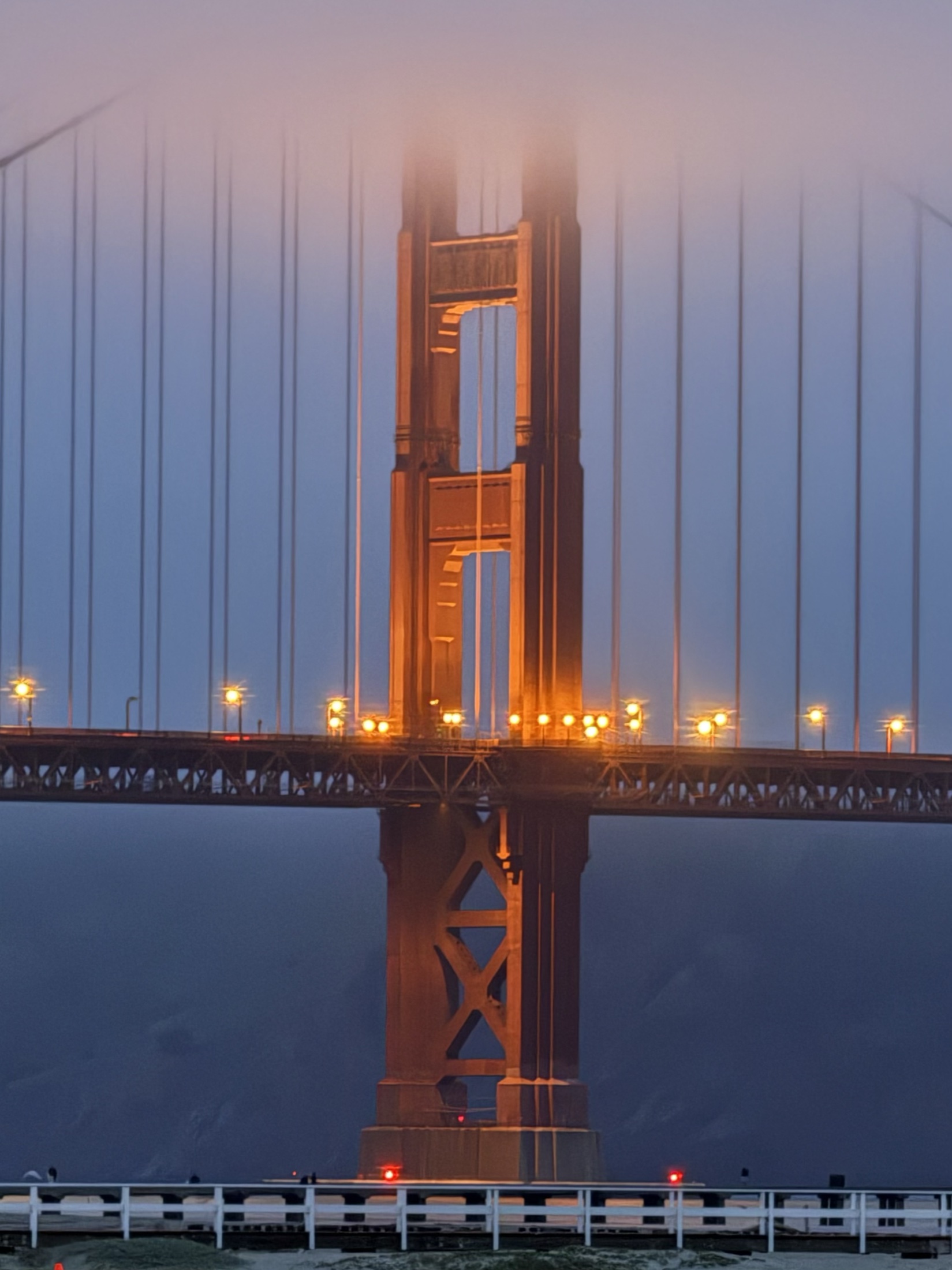 The Golden Gate Bridge's north tower disappearing into fog